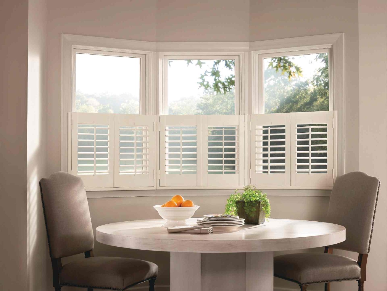 White café style shutters filtering light in a modern dining room near Norwalk, CT.